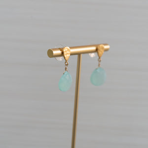 matte gold hammered stud earrings with large blue gemstones handmade in Hawaii by eve black jewelry  Edit alt text