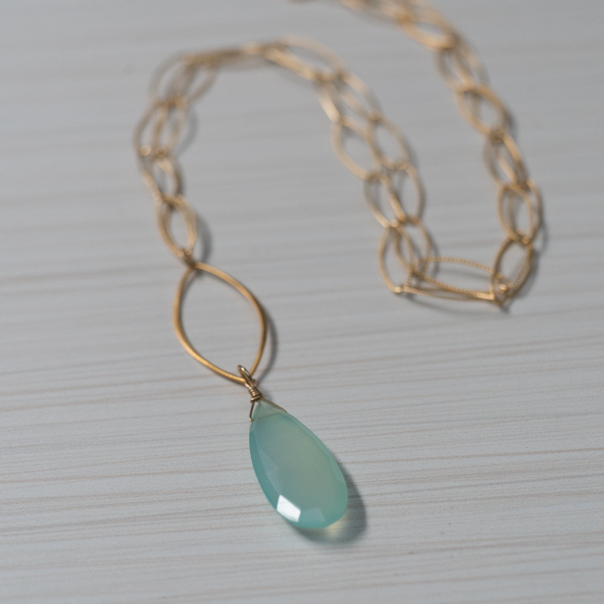 blue gemstone gold necklace handmade in Hawaii by eve black jewelry  Edit alt text