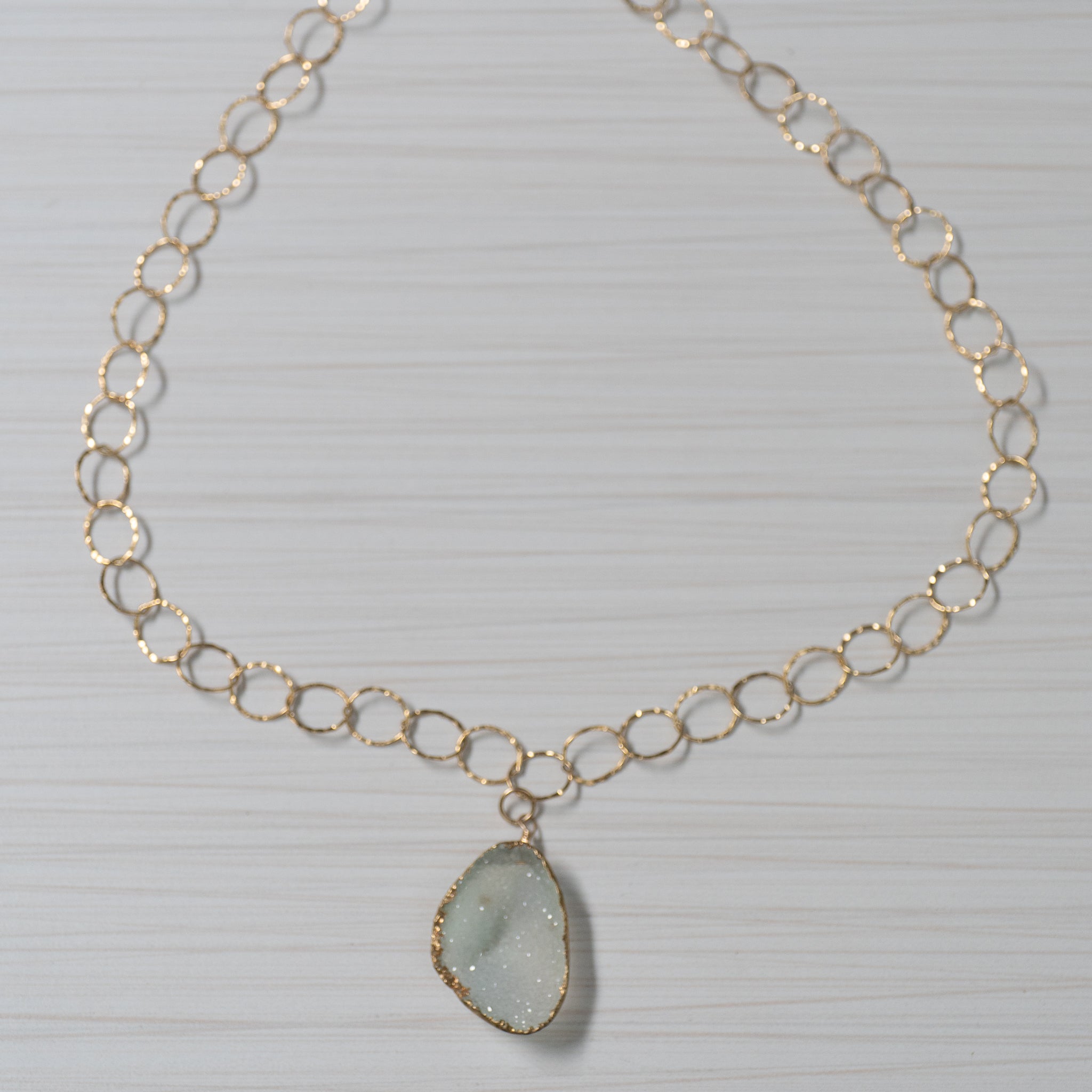 Blue druzy on gold chain necklace handmade in Hawaii by eve black jewelry  Edit alt text